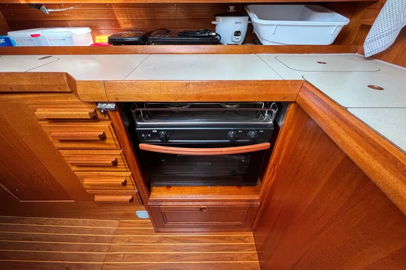 Slide: The Image of Wooden kitchen interior of 1992 Najad 390 yacht with stove and storage drawers. - 42