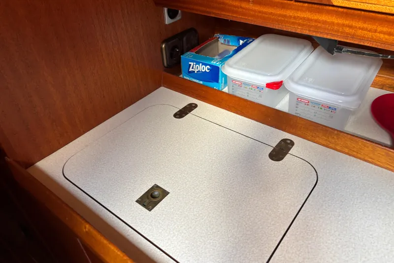 Slide: The Image of Storage compartment in a 1992 Najad 390 yacht with containers and Ziploc bags. - 45