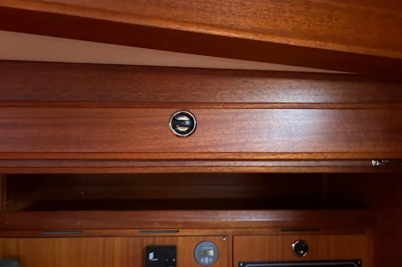 Slide: The Image of Wooden interior detail of a 1992 Najad 390 yacht, featuring a circular handle. - 47