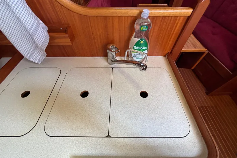 Slide: The Image of Galley sink area on a 1992 Najad 390 yacht with dish soap and faucet. - 49
