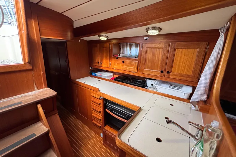 Slide: The Image of Interior of 1992 Najad 390 yacht kitchen with wooden cabinetry and modern appliances. - 55