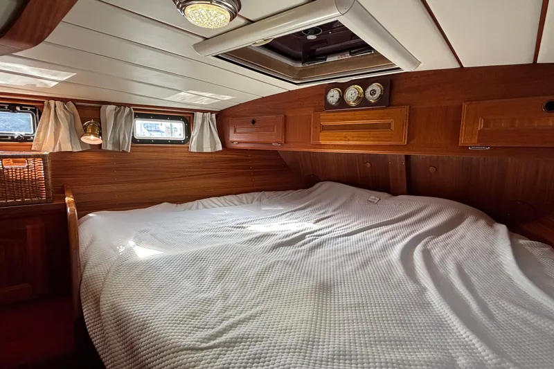 Slide: The Image of Cozy cabin interior of 1992 Najad 390 yacht with wooden finish and white bedding. - 57