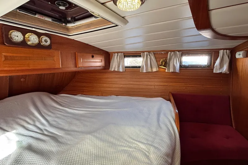 Slide: The Image of Cozy cabin interior of 1992 Najad 390 yacht with wood paneling and porthole windows. - 58