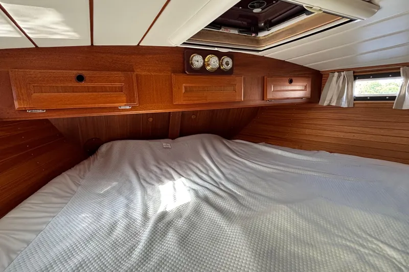 Slide: The Image of Cozy cabin interior of 1992 Najad 390 yacht with wooden finish and comfortable bedding. - 59