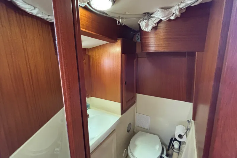 Slide: The Image of Bathroom interior of a 1992 Najad 390 yacht with wooden cabinetry and compact design. - 64