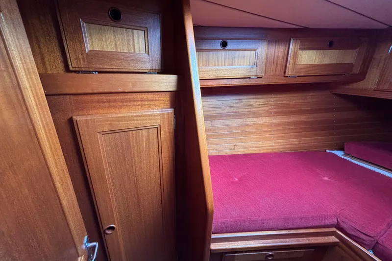 Slide: The Image of Interior of 1992 Najad 390 yacht with wooden cabinetry and red cushioned seating. - 66