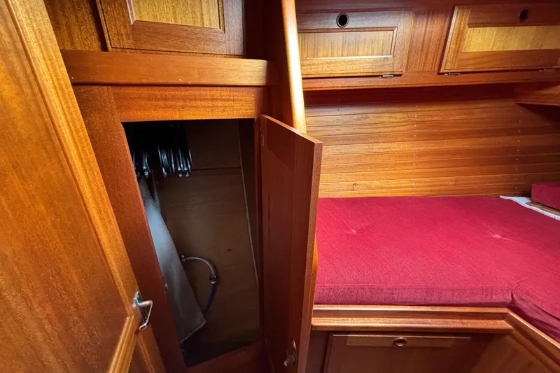 Slide: The Image of Interior of 1992 Najad 390 yacht with wooden cabinetry and red cushioned seating. - 67