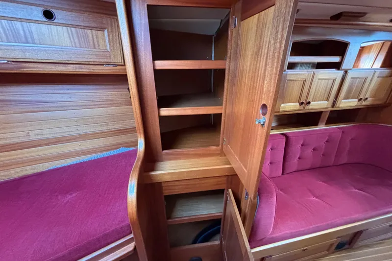Slide: The Image of Interior of 1992 Najad 390 sailboat with wooden cabinetry and red seating. - 69