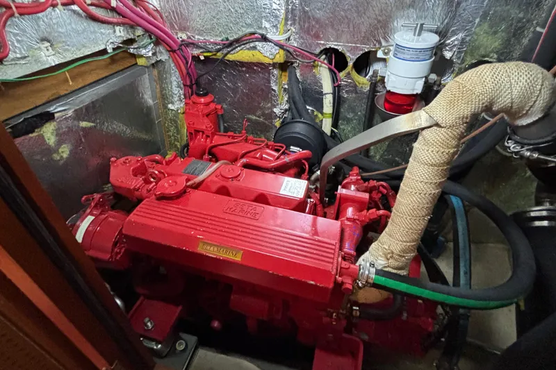 Slide: The Image of Red marine engine in a 1992 Najad 390 yacht, surrounded by insulated wiring. - 73