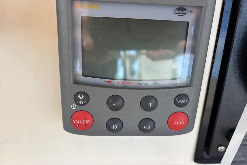 Slide: The Image of SmartPilot control panel on a 1992 Najad 390 yacht, featuring various navigation buttons. - 80