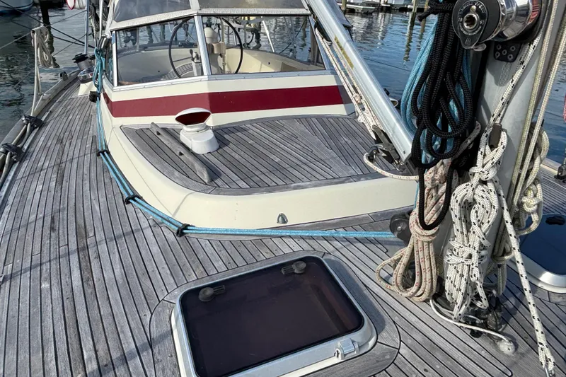 Slide: The Image of 1992 Najad 390 sailboat deck with ropes and cockpit, docked at marina. - 9