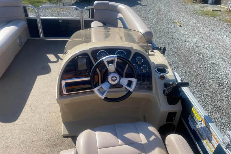 Slide: The Image of 2014 Godfrey SWEETWATER 2086 boat dashboard with steering wheel and control panel. - 10