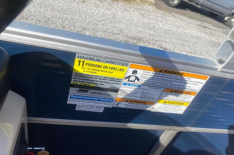 Slide: The Image of 2014 Godfrey SWEETWATER 2086 capacity label, maximum 11 persons or 1492 lbs, safety warnings. - 11