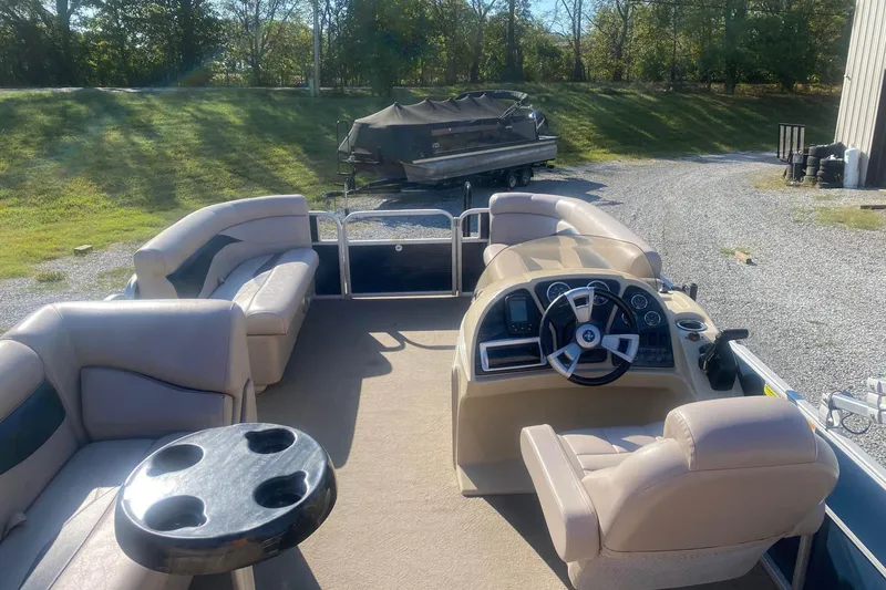 Slide: The Image of 2014 Godfrey SWEETWATER 2086 pontoon boat interior with beige seating and steering console. - 7