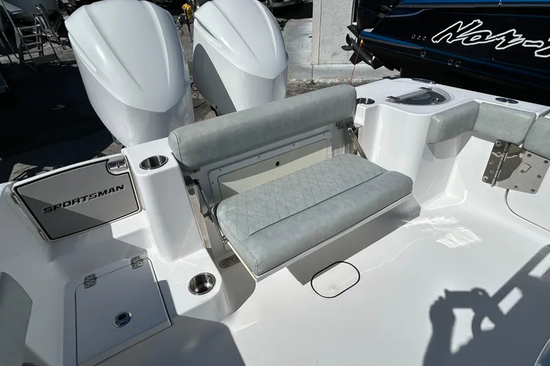 Slide: The Image of 2019 Sportsman Open 282 Center Console boat with cushioned seating and dual engines. - 10