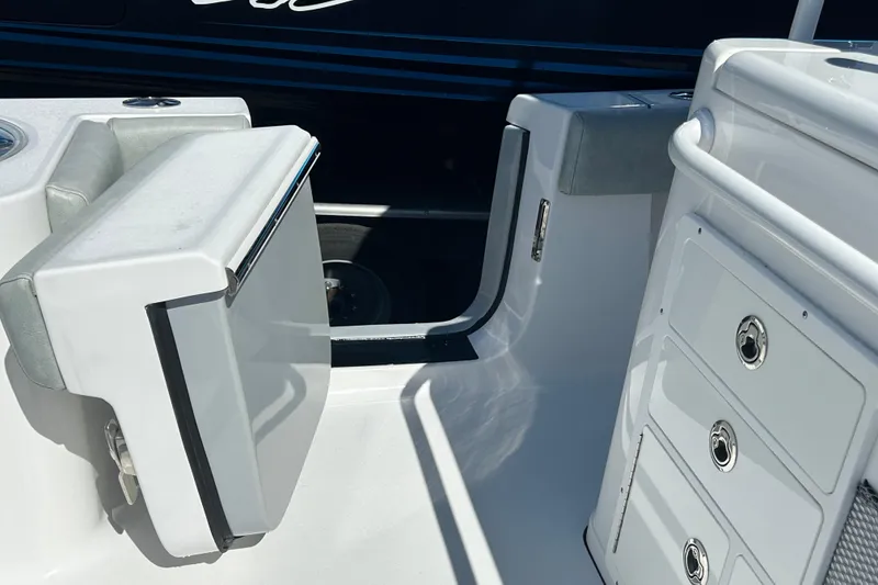Slide: The Image of 2019 Sportsman Open 282 Center Console interior with storage compartments and seating. - 11