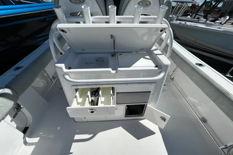 Slide: The Image of 2019 Sportsman Open 282 Center Console boat with open storage compartments and rod holders. - 13