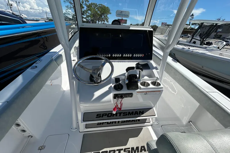 Slide: The Image of 2019 Sportsman Open 282 Center Console boat dashboard with steering wheel and controls. - 14