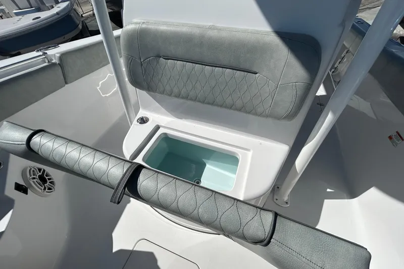 Slide: The Image of 2019 Sportsman Open 282 Center Console interior with cushioned seating and storage compartment. - 20