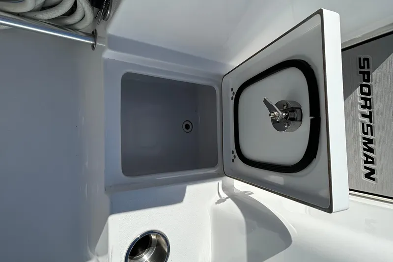 Slide: The Image of 2019 Sportsman Open 282 Center Console boat storage compartment with open lid. - 22