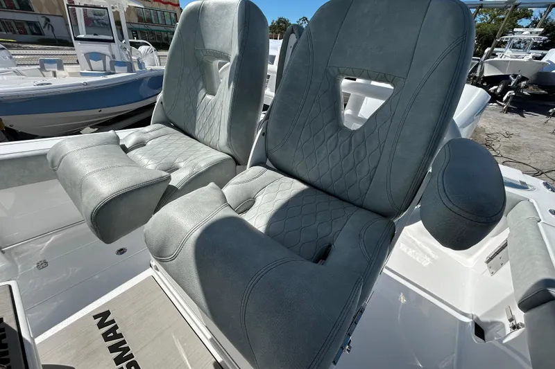 Slide: The Image of 2019 Sportsman Open 282 Center Console boat seats with gray upholstery. - 23