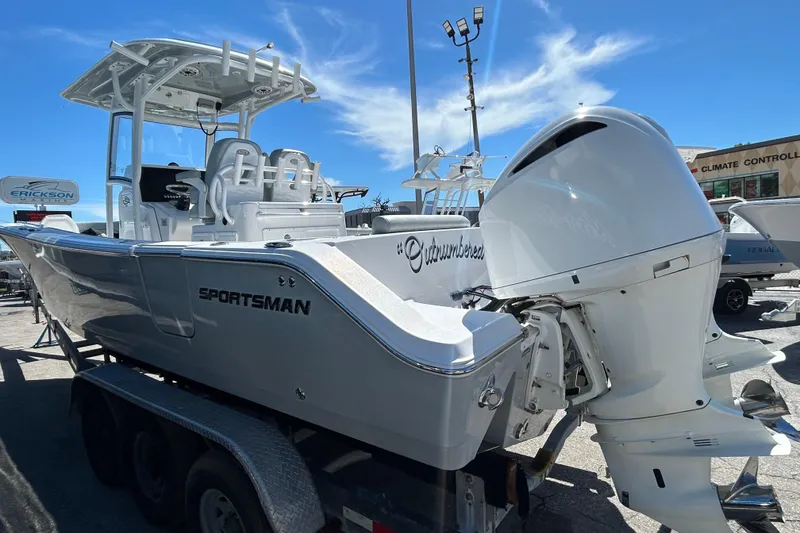 Slide: The Image of 2019 Sportsman Open 282 Center Console boat on trailer under clear blue sky. - 6