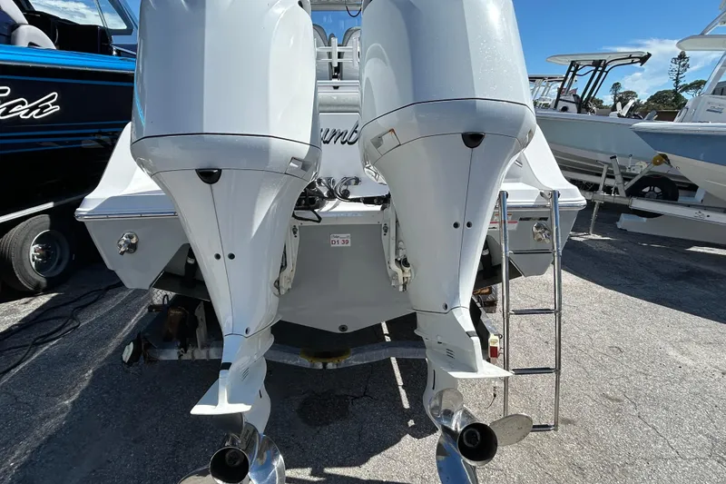 Slide: The Image of 2019 Sportsman Open 282 Center Console with dual outboard motors, rear view. - 7