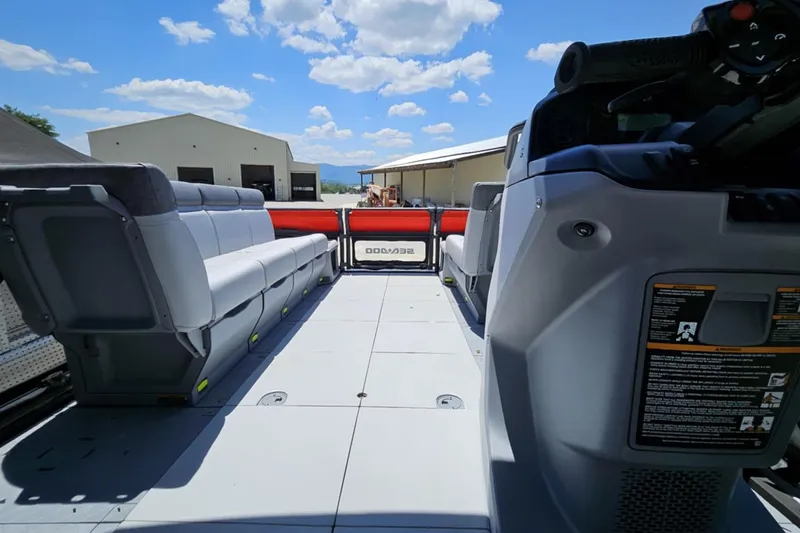 Slide: The Image of 2024 Seadoo Cruise 21 interior with spacious seating, under a clear blue sky. - 3