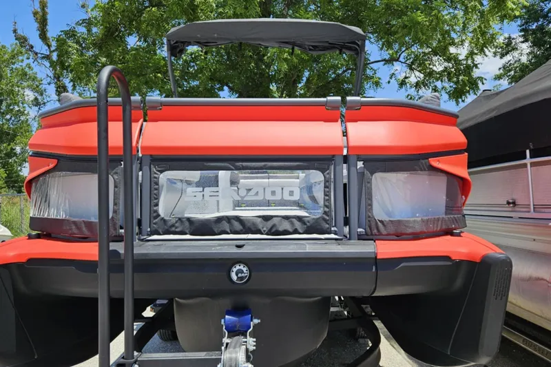 Slide: The Image of 2024 Seadoo Cruise 21 boat, rear view, vibrant red, parked outdoors. - 4