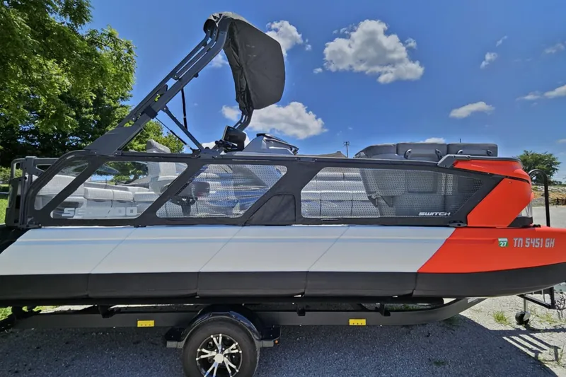 Slide: The Image of 2024 Seadoo Cruise 21 boat on trailer, side view, under clear blue sky. - 8