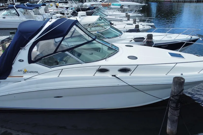 Slide: The Image of 2002 Sea Ray 320 Sundancer docked at marina with other boats. - 11