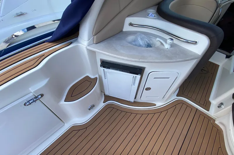 Slide: The Image of Interior of 2002 Sea Ray 320 Sundancer with teak flooring and compact sink area. - 29