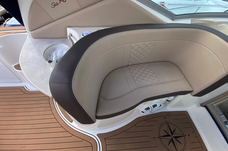 Slide: The Image of Luxurious seating on 2002 Sea Ray 320 Sundancer with compass-themed flooring. - 30