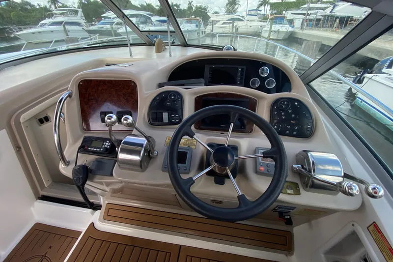 Slide: The Image of Cockpit of 2002 Sea Ray 320 Sundancer with steering wheel and control panel. - 32
