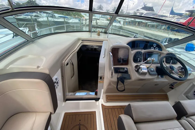 Slide: The Image of Cockpit of 2002 Sea Ray 320 Sundancer with steering wheel and control panel. - 35