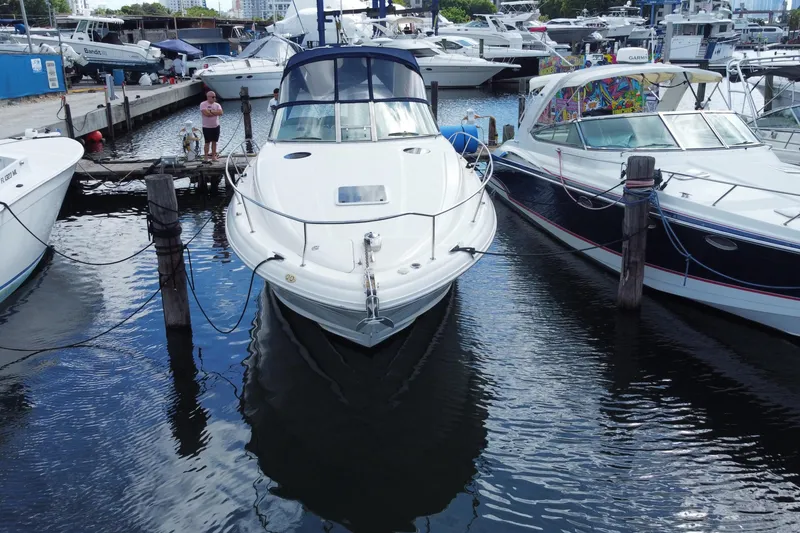 Slide: The Image of 2002 Sea Ray 320 Sundancer docked at marina, surrounded by other boats. - 4