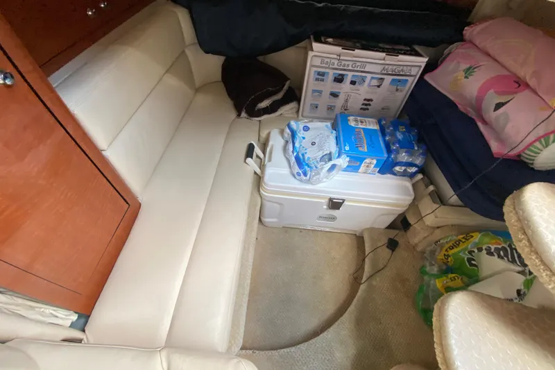 Slide: The Image of Interior of 2002 Sea Ray 320 Sundancer with seating, cooler, and supplies. - 44