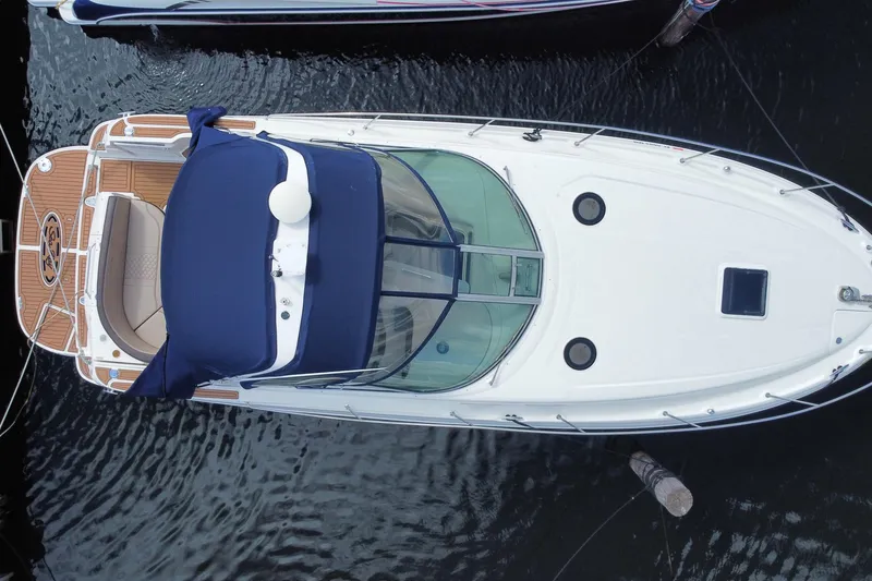 Slide: The Image of Overhead view of a 2002 Sea Ray 320 Sundancer yacht docked in water. - 47