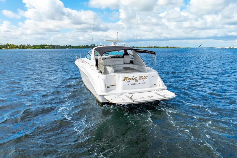 Slide: The Image of 1998 Sea Ray 450 Sundancer yacht "Knot EZ" cruising on open water. - 10