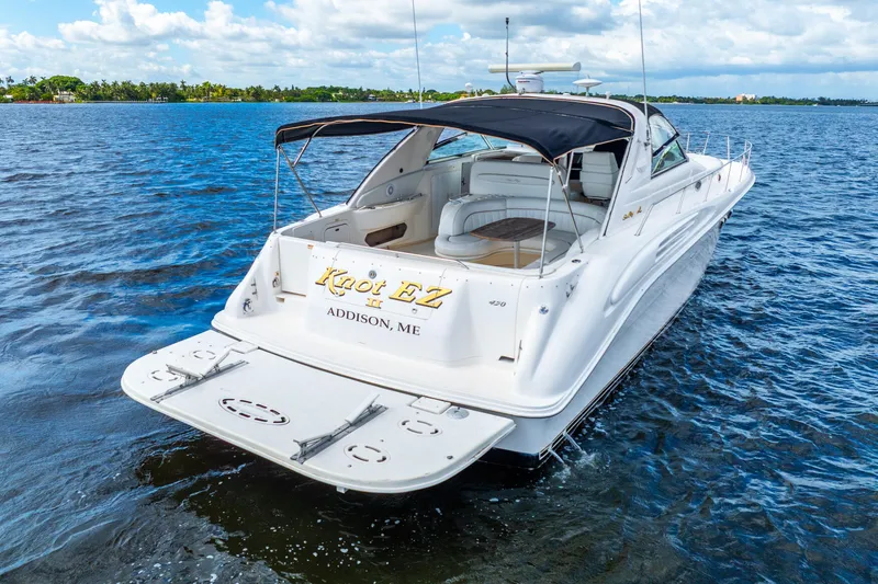 Slide: The Image of 1998 Sea Ray 450 Sundancer yacht on water, featuring sleek design and spacious deck. - 11
