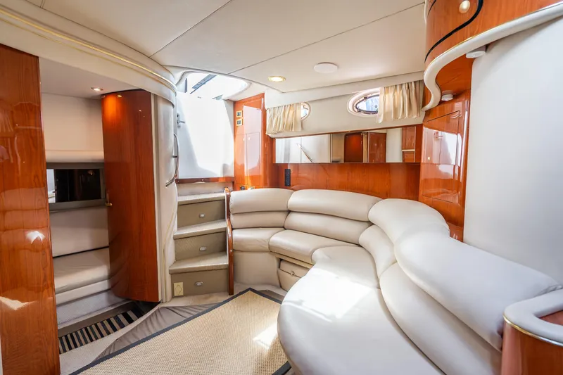 Slide: The Image of Luxurious interior of a 1998 Sea Ray 450 Sundancer yacht with plush seating and wood accents. - 13