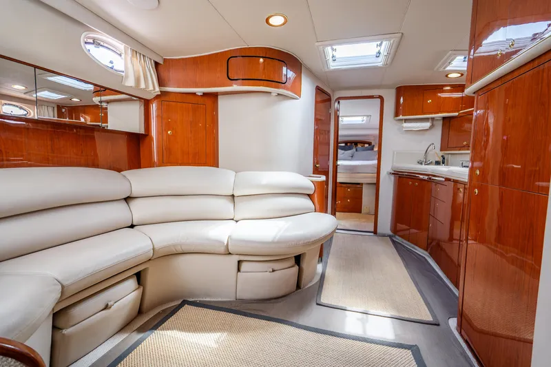 Slide: The Image of Luxurious interior of 1998 Sea Ray 450 Sundancer yacht with plush seating and wood finishes. - 14
