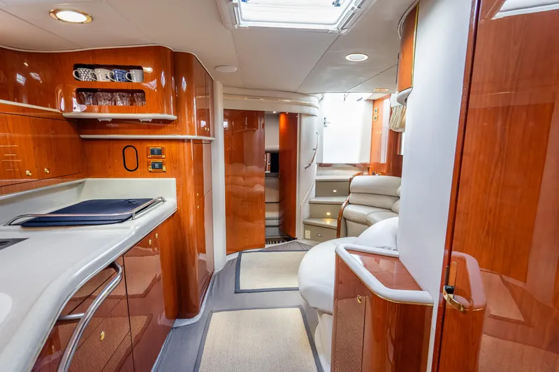 Slide: The Image of Luxurious interior of 1998 Sea Ray 450 Sundancer yacht with polished wood and modern amenities. - 15