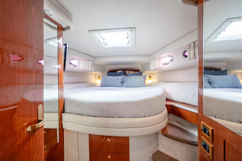 Slide: The Image of Luxurious cabin interior of 1998 Sea Ray 450 Sundancer yacht with cozy bedding. - 18