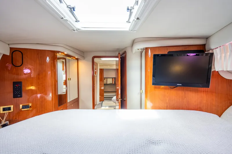 Slide: The Image of Luxurious interior of 1998 Sea Ray 450 Sundancer yacht with TV and wood paneling. - 20