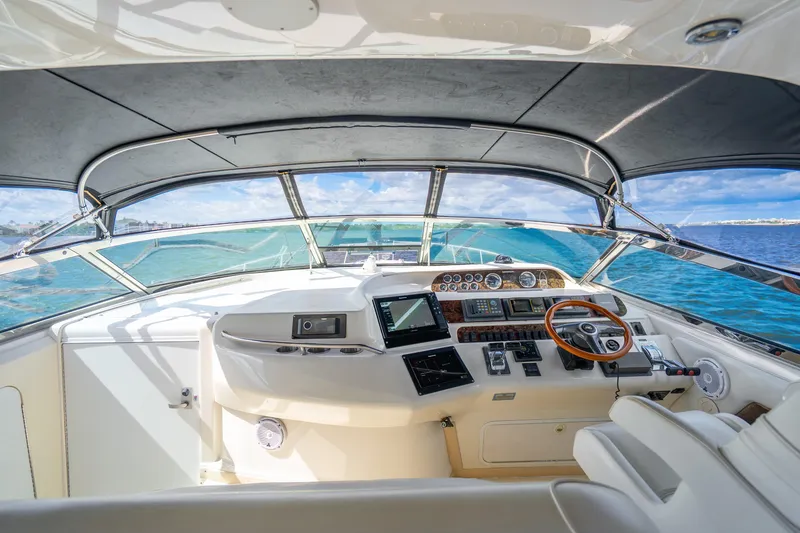Slide: The Image of 1998 Sea Ray 450 Sundancer helm with ocean view, featuring modern navigation equipment. - 23