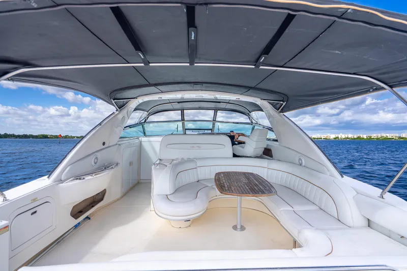 Slide: The Image of 1998 Sea Ray 450 Sundancer yacht interior with seating and table on open water. - 31