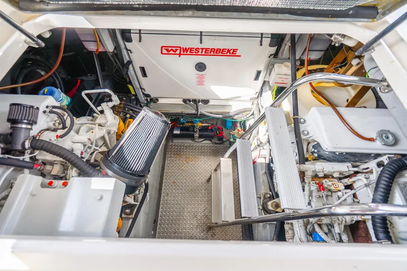 Slide: The Image of Engine room of 1998 Sea Ray 450 Sundancer with Westerbeke generator and mechanical components. - 33