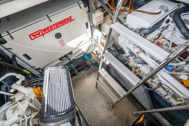 Slide: The Image of Engine room of 1998 Sea Ray 450 Sundancer with Westerbeke generator and ladder access. - 35