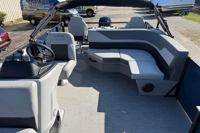Slide: The Image of 2026 Lowe LF 194 boat interior with modern seating and steering console. - 12